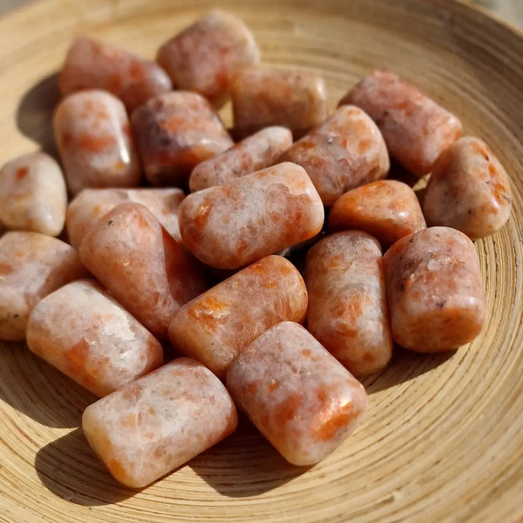 Tas de cristaux de soleil Héliolite aux teintes orange et blanche.